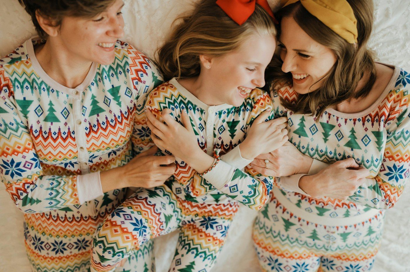 Mother and children in matching printed pajamas